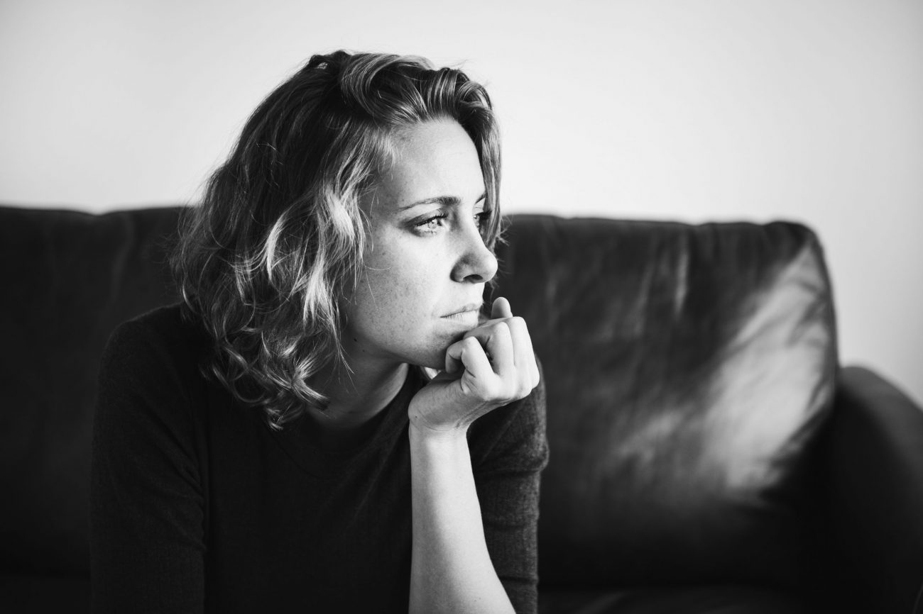 woman-black-white-rawpixel Black-and-white photo of woman gazing into the distance illustrate blog "What Are Some Signs of Domestic Abuse?"
