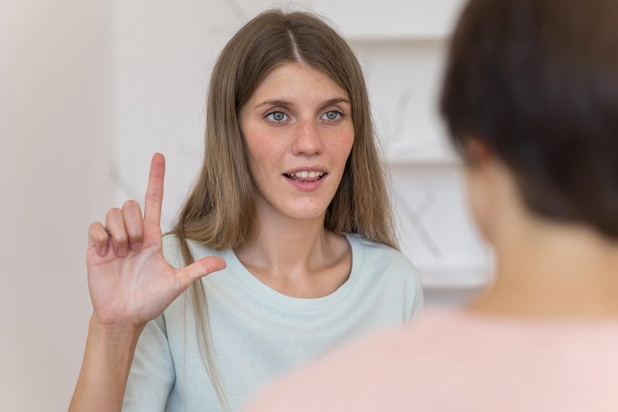 sign-language-fp Woman using sign language illustrates blog "What if I Am Deaf and I Have To Go to Court for a Restraining Order Case?"