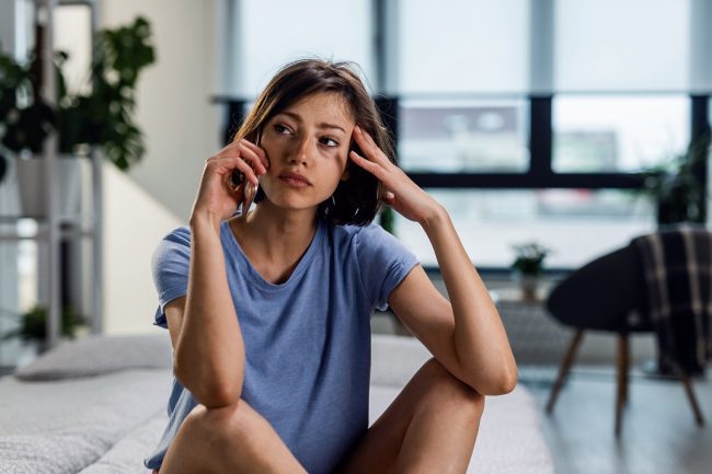Woman talking on the phone illustrates blog "Is Domestic Abuse Only Physical?"