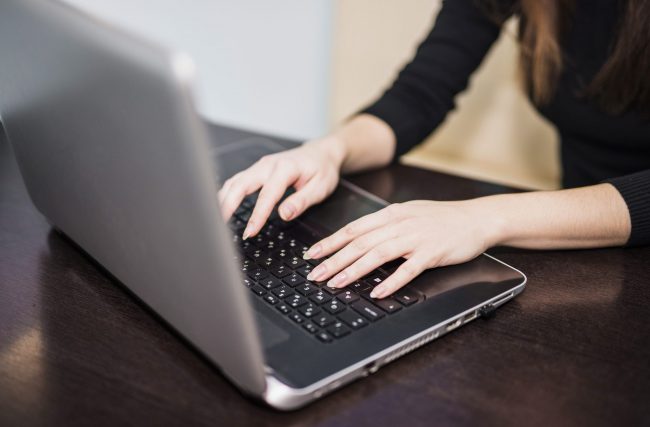 woman-laptop3-fp Closeup of woman pressing laptop keys illustrates blog "What Is the California Law Enforcement Telecommunications System (CLETS)?"