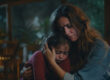 Child comforted by a caregiver while recovering from domestic violence trauma