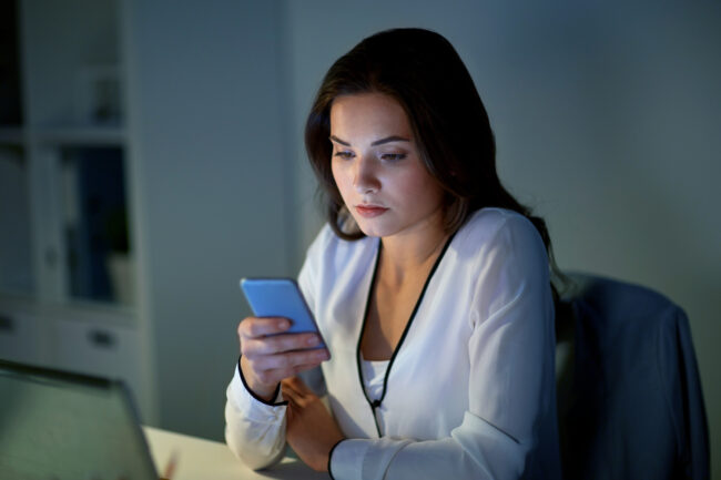 businesswoman with smartphone at office