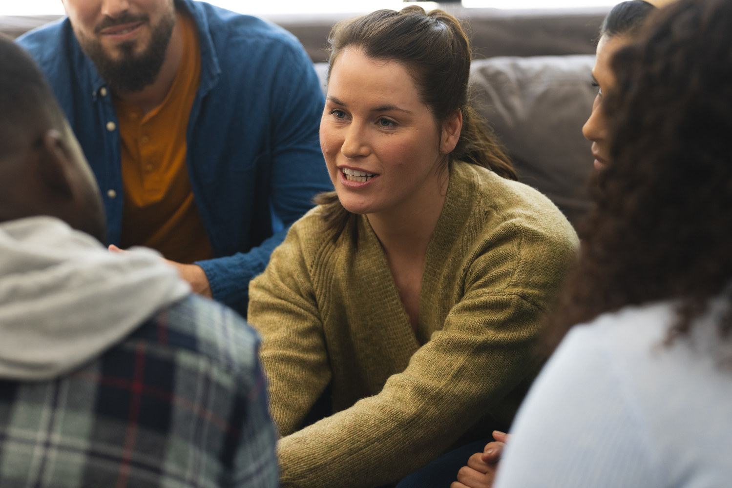 Diverse group of friends talking and supporting each other on therapy session. Mental health, therapy, friendship and support, unaltered.