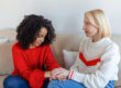 Woman comforting a friend while discussing domestic abuse support