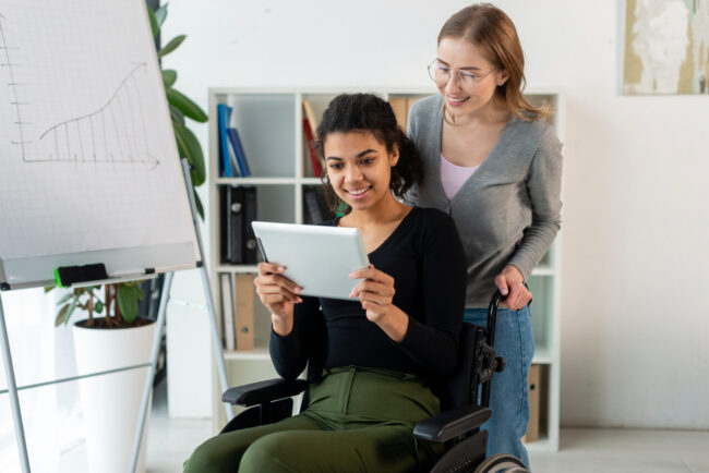 front-view-adult-women-browsing-tablet Survivor with a disability creating a safety plan with support advocate in Riverside, California