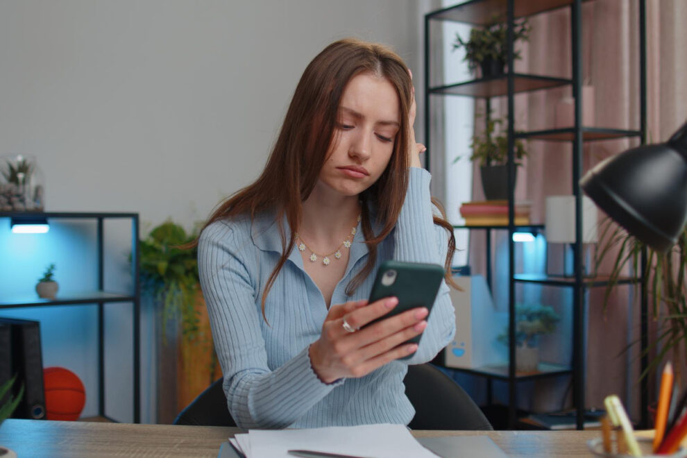 Woman preparing for leaving an abusive partner by reviewing documents privately