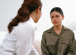 Advocate discussing intimidation tactics in abusive relationships with a survivor